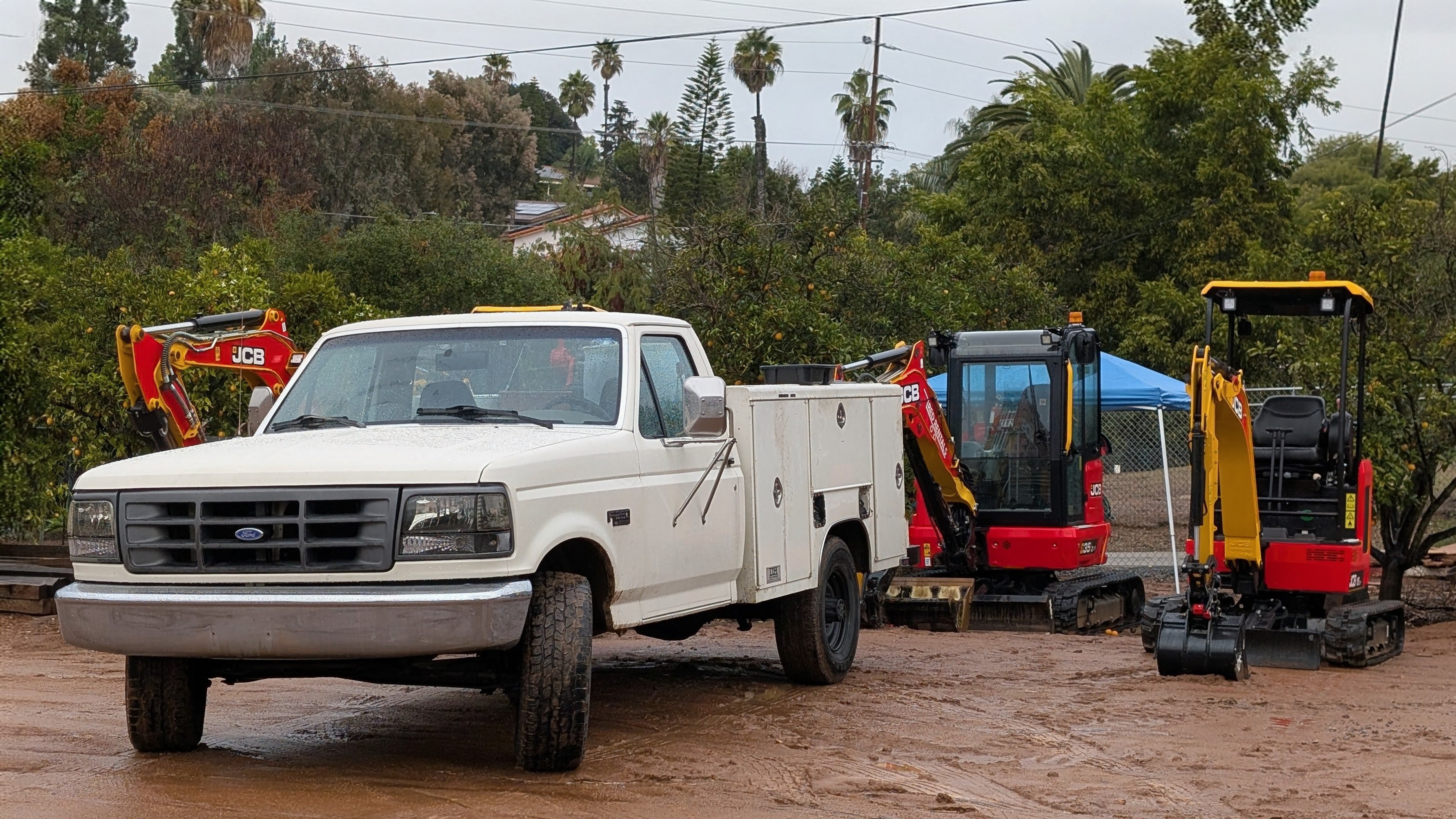 F-250 service truck on site with JCB excavators