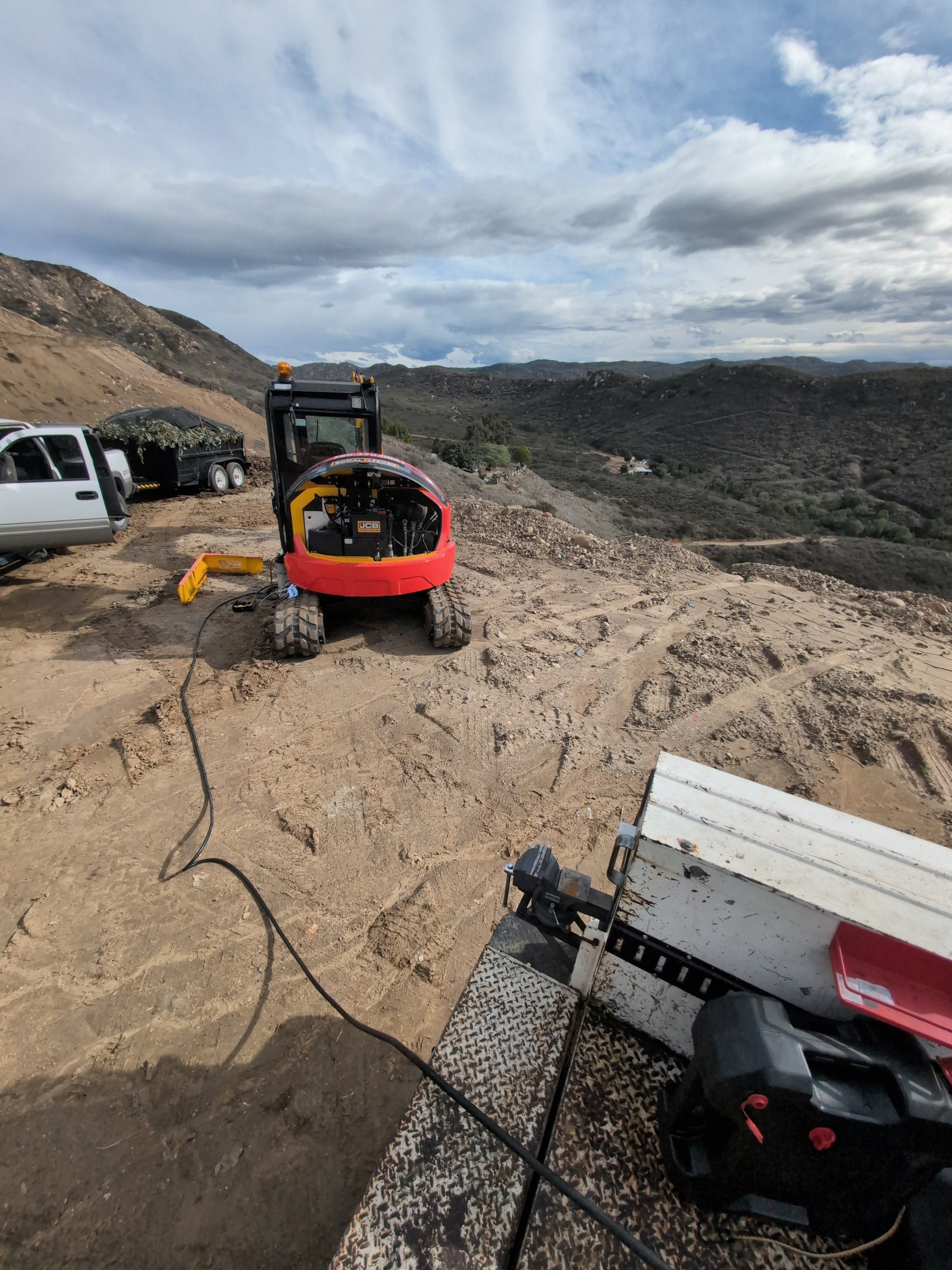 Excavator on a hilltop jobsite
